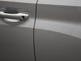 the door handle of a white car with a black handle
