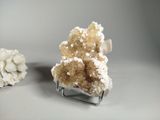two pieces of white and brown crystals sitting on top of a table