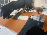 a desk with two monitors and a keyboard on it