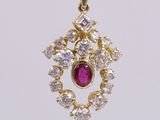 a close up of a red and white diamond pendant on a red cord