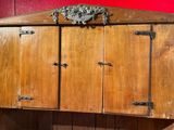 a wooden cabinet with two doors and a door handle on it