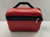 a red suitcase with a black handle on a white table