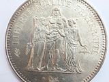an image of a coin with the image of a man and a woman on it