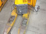 a yellow forklift with a television on top of it