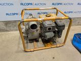 a small pump sitting on the ground next to a blue container