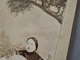 an old photo of a woman sitting on a bench with a cat