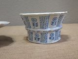 a small blue and white bowl and a small white bowl on a table