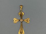 une image représentant une croix dorée sur fond gris