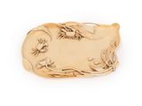 a gold plate with a bird and flowers on it