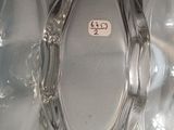 a clear glass vase with a silver lid on a table