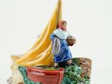 a figurine of a man on a boat with a banana