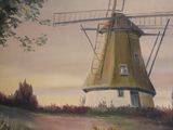 a painting of a windmill on the wall of a house