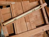 a pile of wooden chairs in a box on the floor