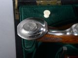 a silver telephone sitting in a case on a table