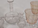 a lot of glasses and vases sitting on a table