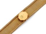 a close up of a gold watch on a gold bracelet