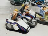 two figurines of people riding on a motorcycle and a motorcycle