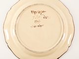 a plate with writing on it on a white surface