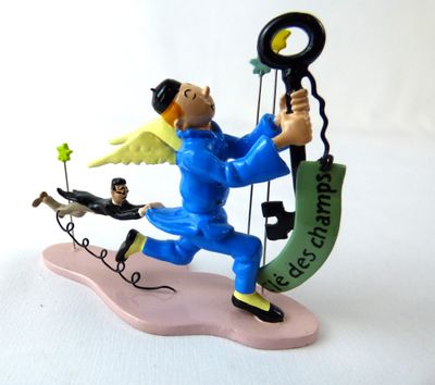 a figurine of an angel holding a key and a man on a swing