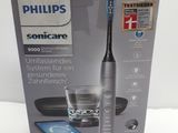 packaging of a philips soniccare electric toothbrush with a glass of water