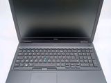 the dell laptop is open and ready to use on the table