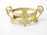 gold plated bowl with handles and handles on a white surface