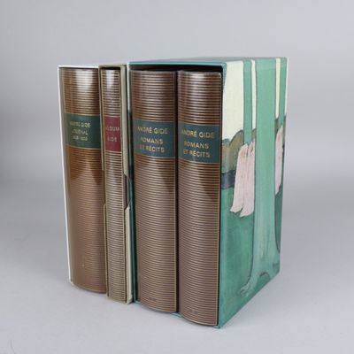 three books are stacked on top of each other on a white surface