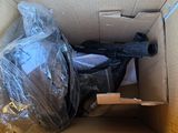a cardboard box with a gun inside of it