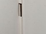 a picture of a corner of a white wall with a hole in it