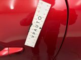 a red car with a ruler on the side of it