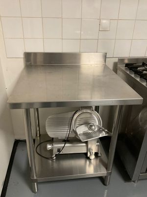 a kitchen with a stove, sink, and oven in it