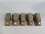 five toy army vehicles are lined up in a row on a white surface