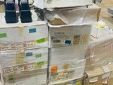 a large stack of boxes and boxes in a warehouse