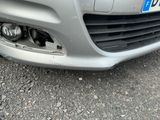a close up of a car ' s front bumper with a number plate on it