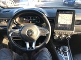 the interior of a car with a steering wheel, dashboard, and a touch screen