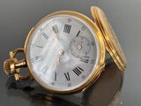 a gold pocket watch with roman numerals on it