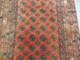 an orange and blue rug with a design on it