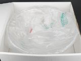 a white box with a plastic bag on top of it