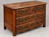 a wooden chest of drawers with ornate carvings on the drawers