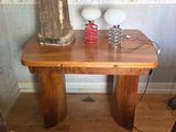 a small table with two lamps on it and a lamp on top of it