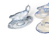 three pieces of blue and white porcelain on a white surface