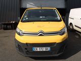 yellow citroen van parked in front of a building next to a white van