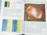an open book with a picture of a galaxy in it