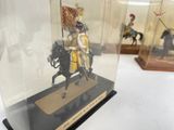 a display case with a figurine of a man on a horse