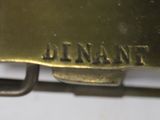 a close up of a metal buckle with a name on it
