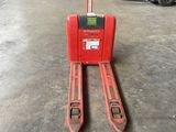 a red forklift in a warehouse with a fork on it