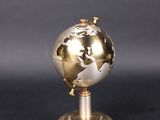 an image of a gold and silver globe on a metal stand