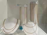two necklaces on display in a glass case