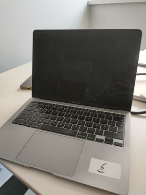 laptop computer sitting on a desk in a room with a checkered floor