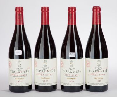 trois bouteilles de vin rouge sont alignées sur une surface blanche
